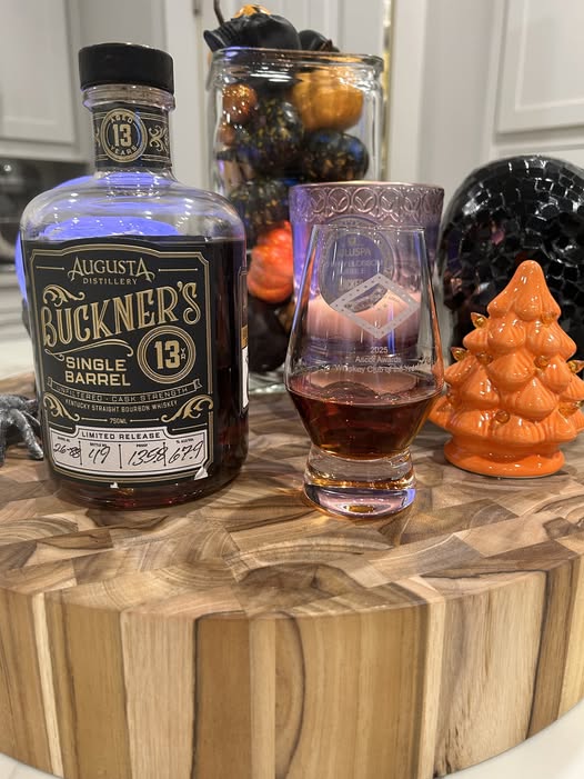 Buckner’s 13-Year Single Barrel bourbon, BCA Barrel #2688 at 135.8 proof, beside a glass of bourbon in Tyler Shinabery’s review photograph.